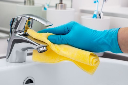 Technician using safe cleaning practices with protective equipment